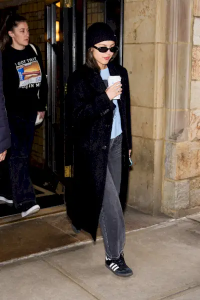 Olivia Rodrigo wears jeans and sneakers.