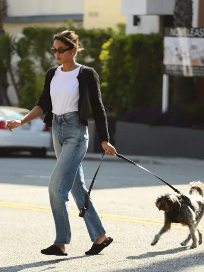 Laura Harrier wears straight-leg jeans and mules.
