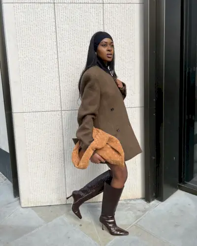 Georgia wearing brown knee-high boots