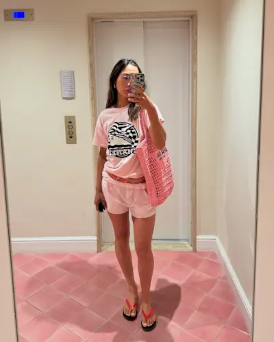 Woman holding a designer beach bag from Prada.