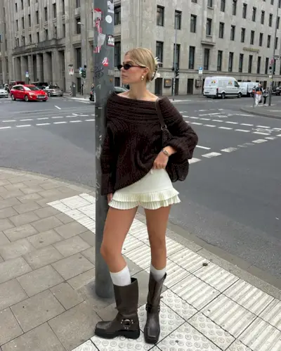 Influencer Linda wears brown Source Unknown jumper with a butter yellow mini skirt and biker boots.