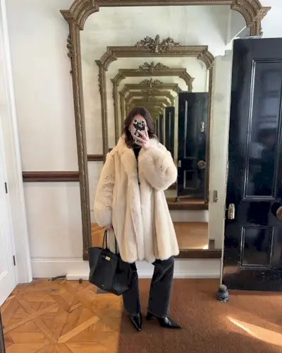 woman wearing white fur coat and light black jeans