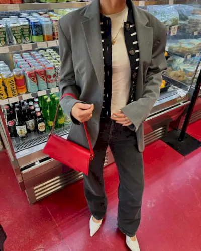 woman wearing grey blazer and light black jeans