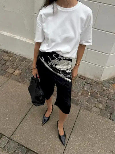 Influencer wearing croc-embossed slingback shoes.