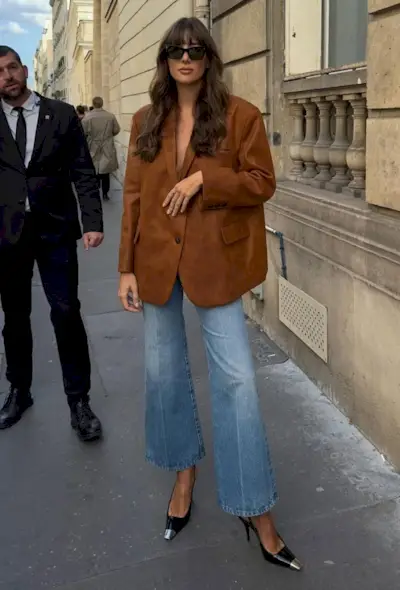 @juliesf wears cropped flare jeans with a suede blazer and heels