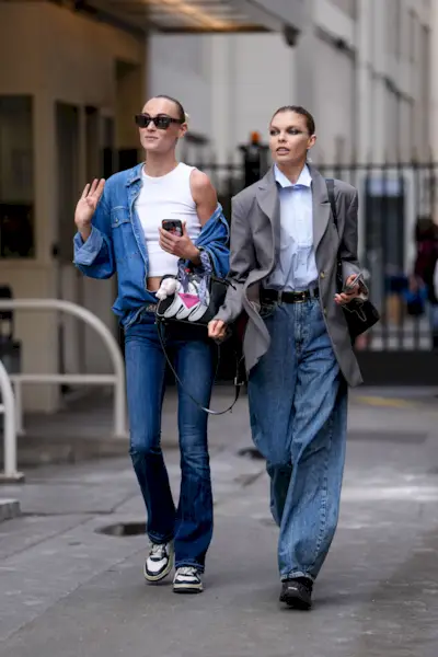 a street style photo of two women wearing jeans