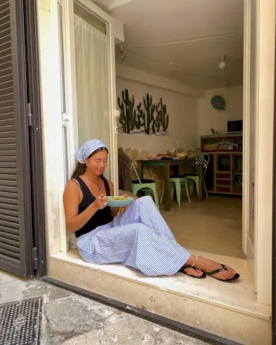 Elegant Summer Style: @sasha.mei wears blue cotton striped trousers with a black top