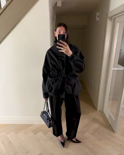 @sarahlouiseblythe wears black barrel trousers