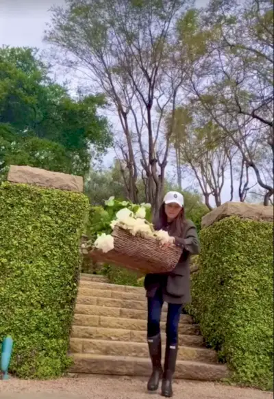 Meghan Markle smiles and looks away from the camera.