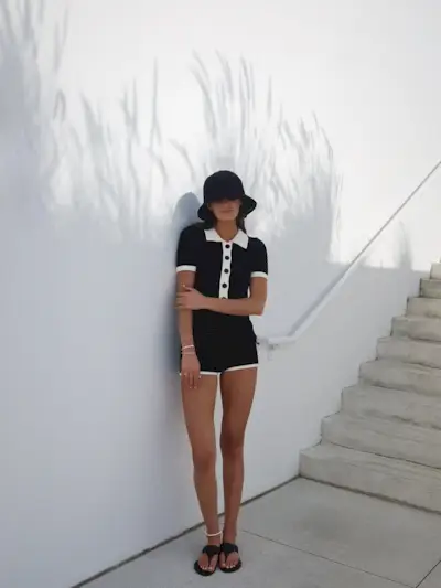 woman wearing matching set with bucket hat and leather sandals