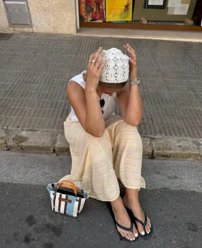 woman wearing yellow pants and black flip flops