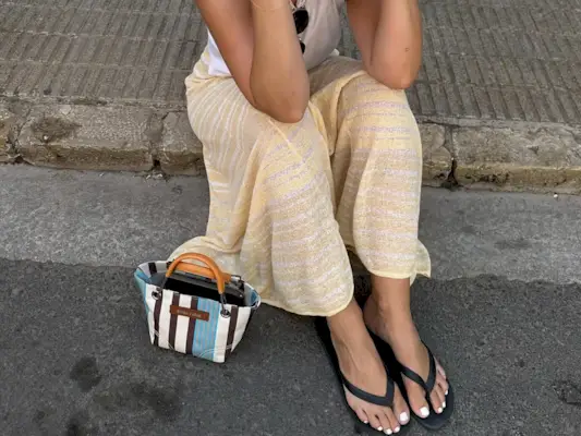 woman wearing yellow pants and black flip flops