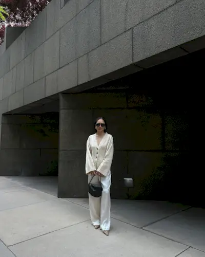 Influencer wears a cream cardigan.