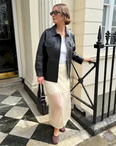 Sophie Robyn Watson wears a sheer skirt, white tank top, black leather jacket and mesh sheer ballet flats