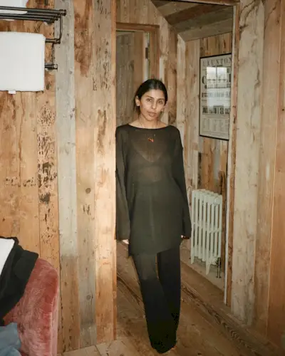 Woman wearing a boatneck top.