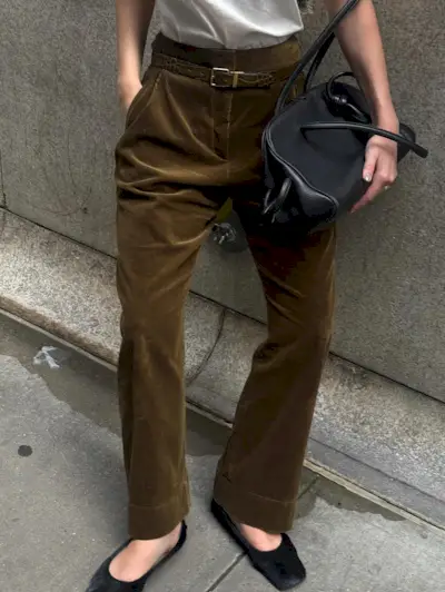 Influencer wearing brown pants and calf hair black flats