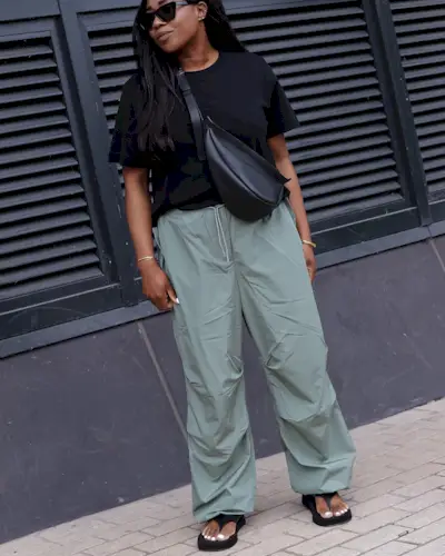 @_loissterling wears cargo trousers with a black leather crossbody bag and a black tee