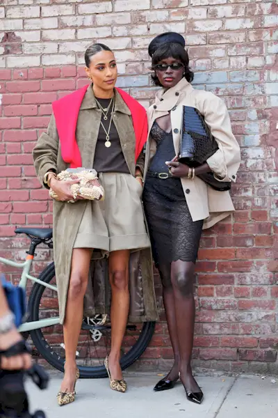 Woman wearing a red accent sweater during NYFW S/S 26.