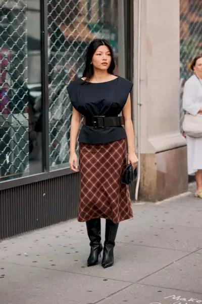 Woman wearing check print clothing during NYFW S/S 26.