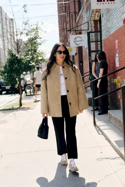Woman wearing tan outerwear during NYFW S/S 26.
