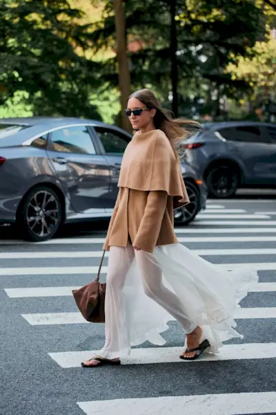 Woman wearing tan outerwear during NYFW S/S 26.